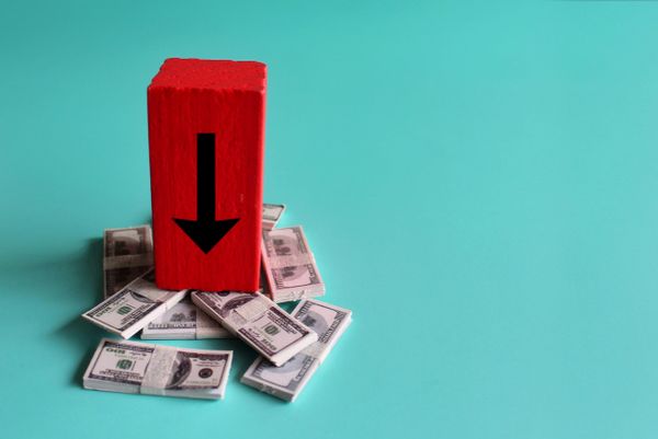 A red block with a down arrow atop miniature $100 bills 