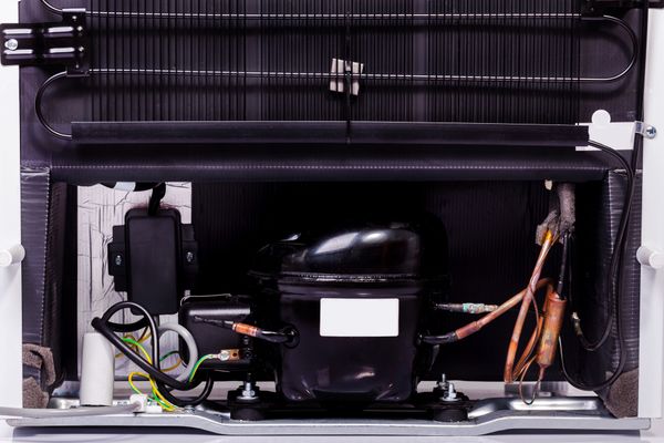 A close-up of a refrigerator condenser 
