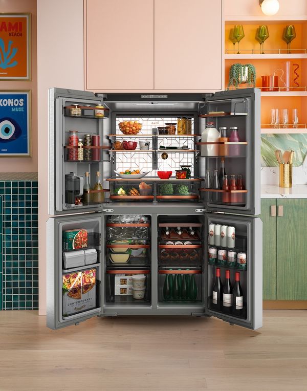 Fully stocked interior of a Cafe 4 door refrigerator with backlit LED wall.
