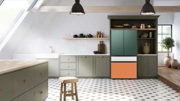 A green, orange, and white Bespoke refrigerator in a stylish, eclectic kitchen