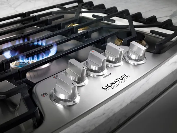 A close-up of the Signature Kitchen Suite UPCG3054ST cooktop vignette 