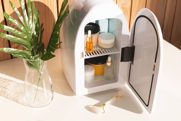 Aerial view of a skincare refrigerator with its door open revealing products 