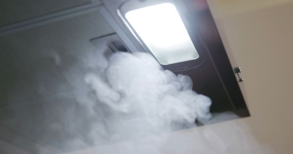 A close-up of smoke and a range hood  