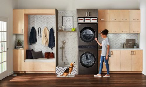 Woman Using a Stacked Washer and Dryer