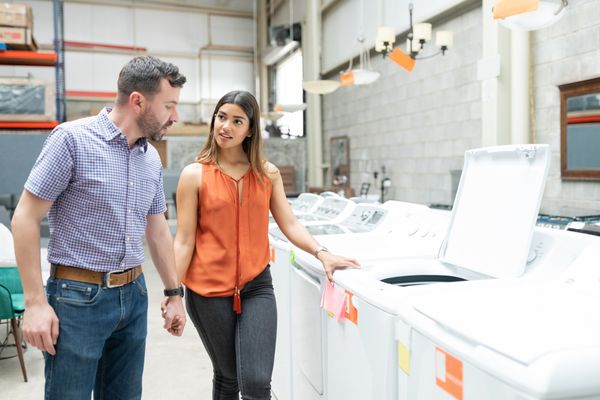A couple shopping for a top load washer 