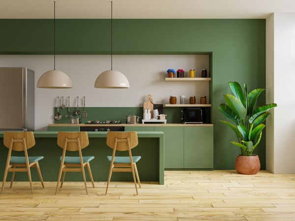 A green-themed kitchen with décor and appliances 