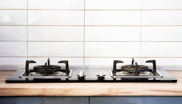 A two-burner gas cooktop installed into wooden countertops 