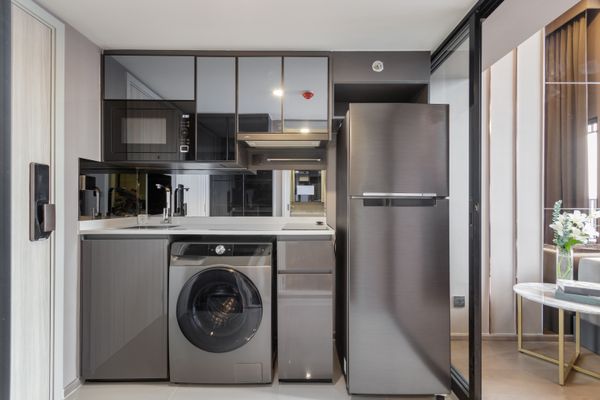 A front load washer in a kitchen 