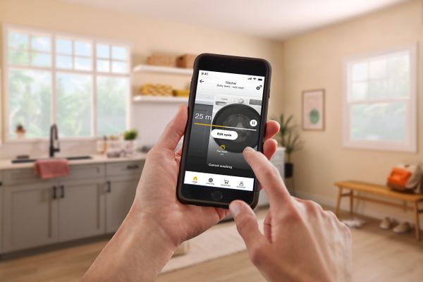 A person using a smart device to run the Whirlpool WGD5720R dryer