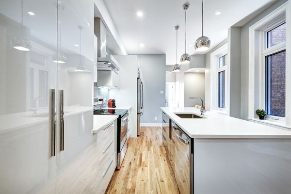 Straight view into a modern, white galley-style kitchen 