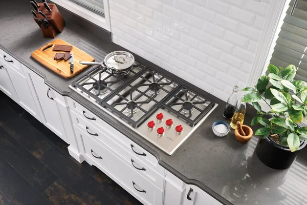 The Wolf CG365P_S cooktop cooking a variety of food 
