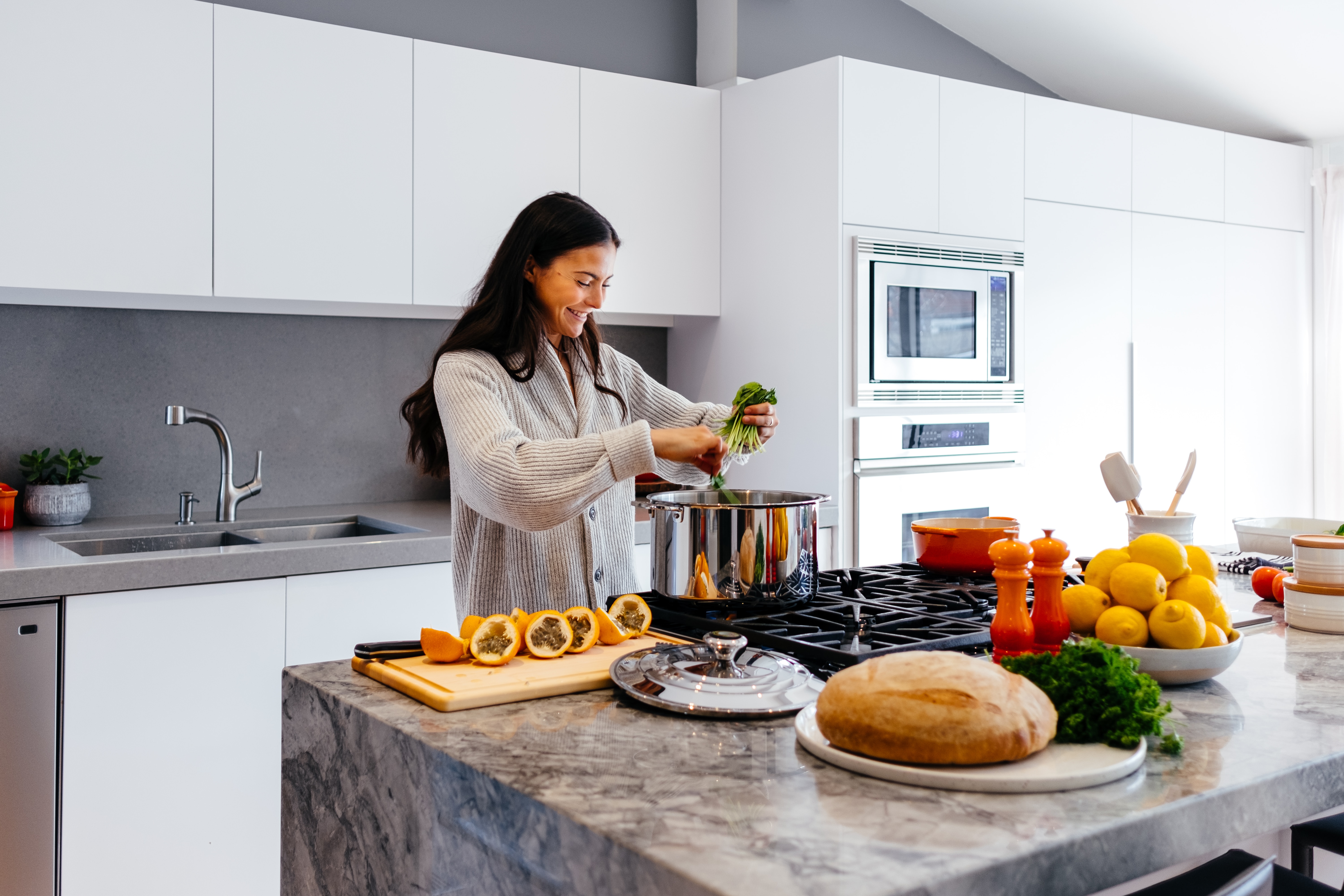 Woman Cooking In Kitchen on Luxury Range