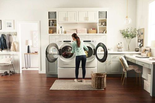 Woman Loading a Front Load Washer and Dryer