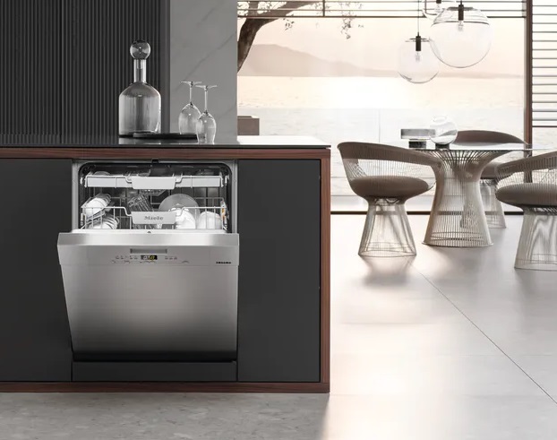 The Miele G 5006 SCU with its door open inside a luxury kitchen 