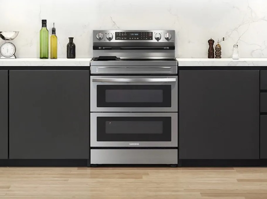 Stainless steel Samsung double oven electric range is shown installed in a modern kitchen