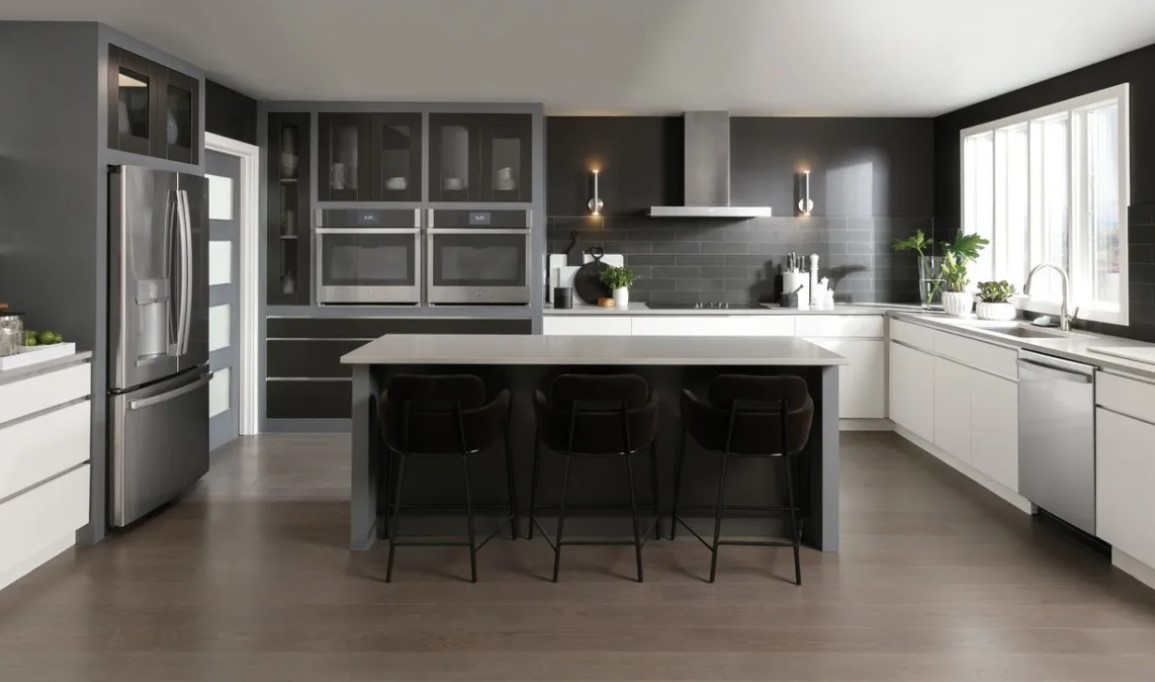 A modern kitchen featuring a full suite of stainless steel GE Profile appliances.