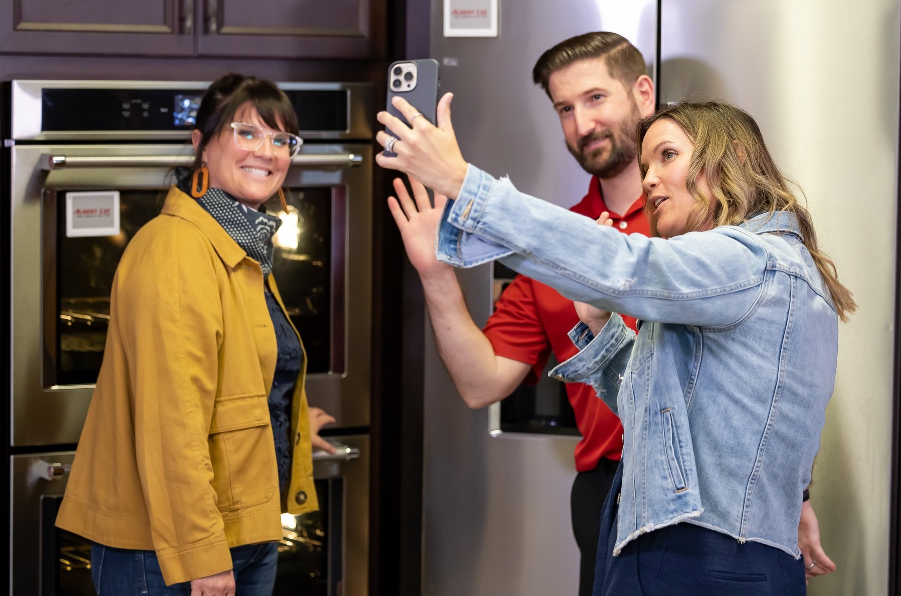 Albert Lee store manager Eric Mulkin taking a photo with Lyndsay Lamb and Leslie Davis from Unsellable Houses