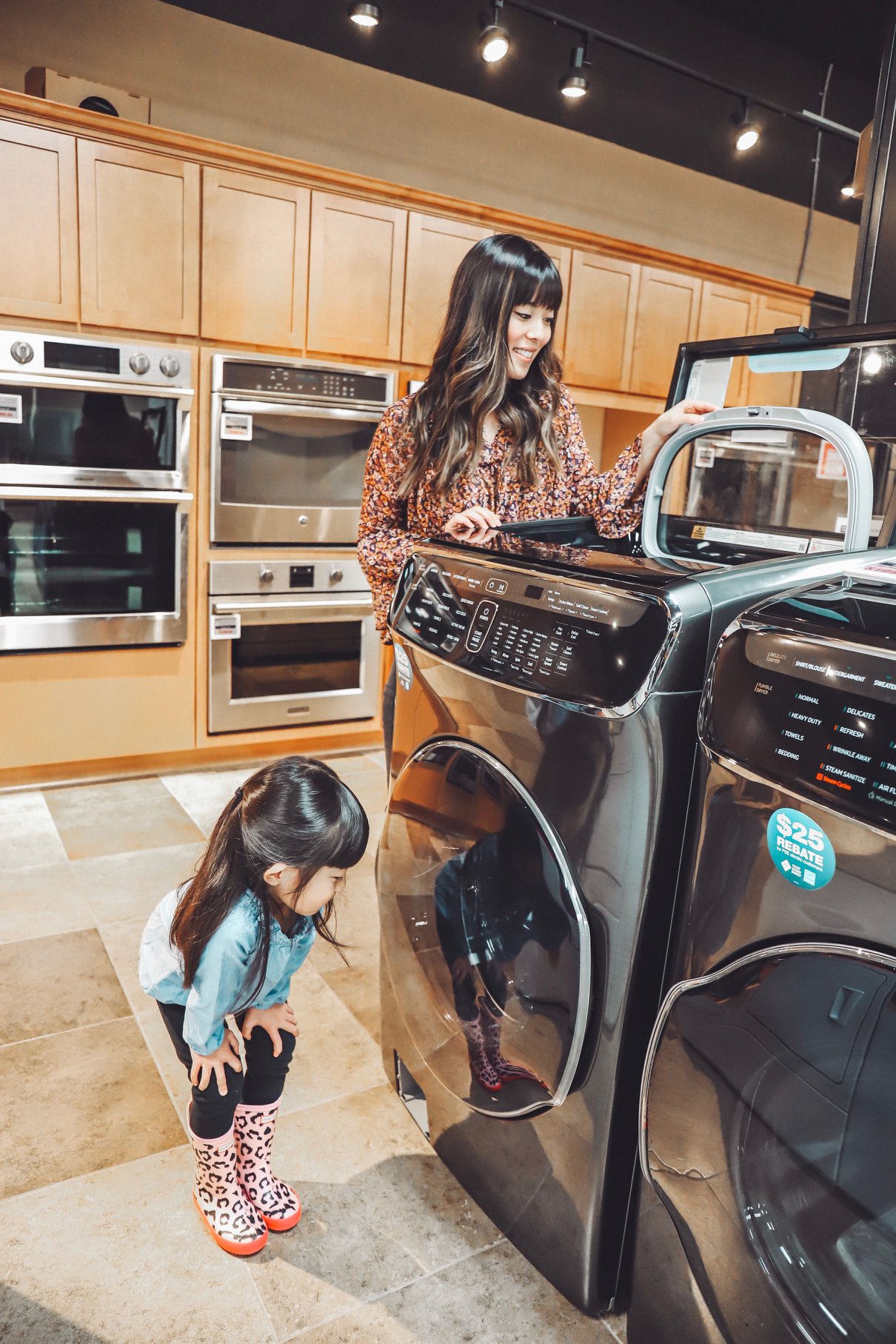  A woman and her daughter shopping laundry appliances at Albert Lee 
