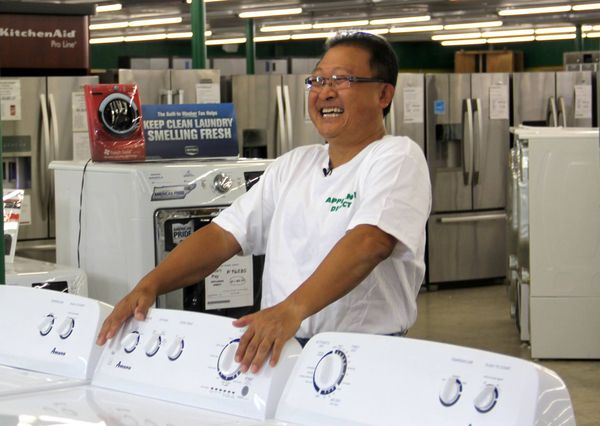 Appliance Direct founder Sam Pak smiling inside an Appliance Direct