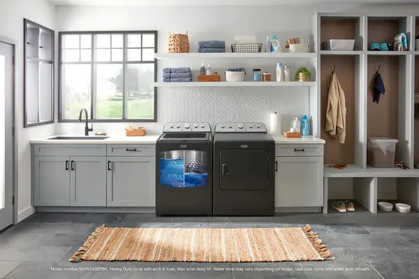 A matching Maytag volcano washer and dryer in a laundry room