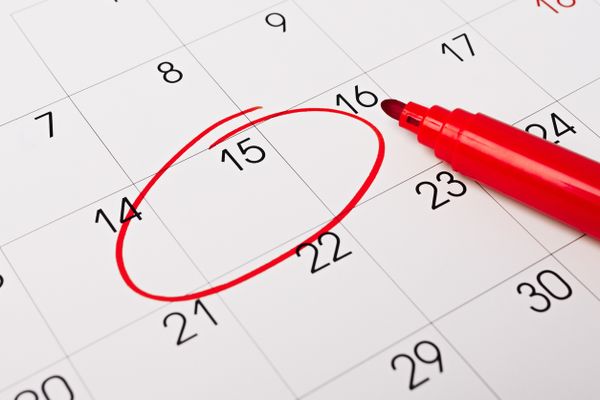 A red marker circling the 15th month on a calendar 