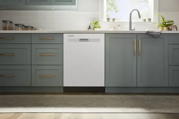 The Whirlpool WDP540HAMW dishwasher featured in a sage-green-themed kitchen