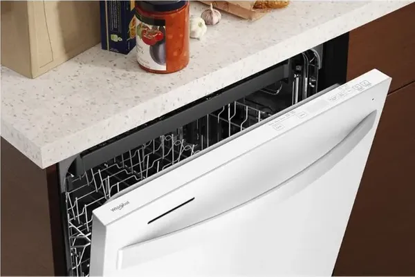 A white Whirlpool dishwasher shown with its door open