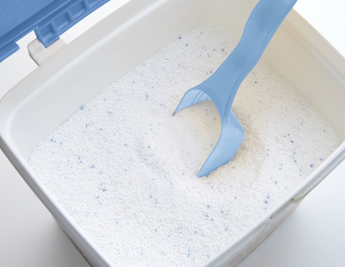 Box of powdered dishwasher soap with scoop inside.