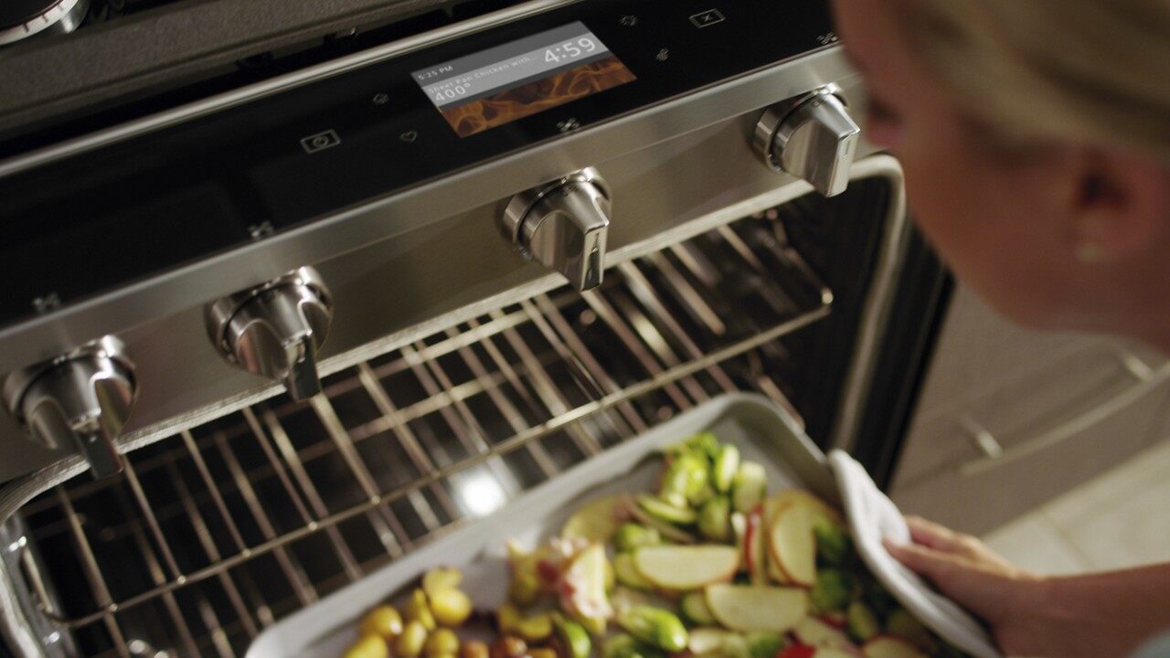 putting pan of veggies in the oven