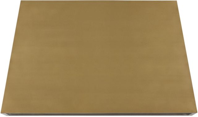 Stock photo of a brass Monogram brand range hood.