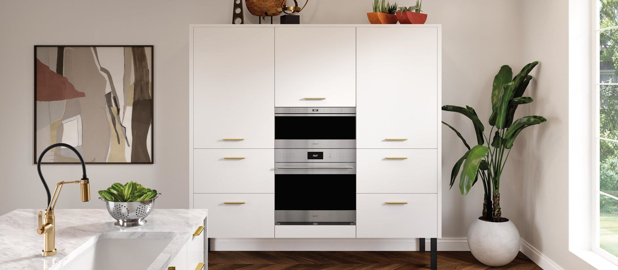 A modern white kitchen with Wolf built in ovens
