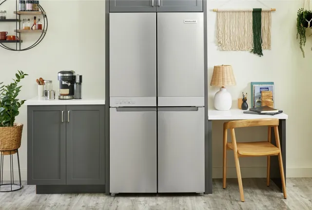 The KitchenAid KRQC506MPS quad-door refrigerator installed in a kitchen cutout