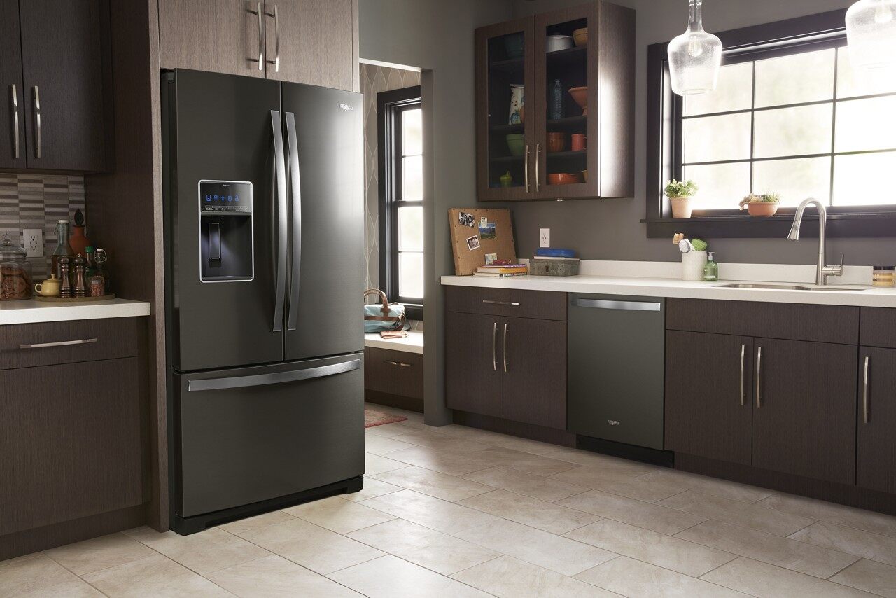 A Whirlpool black stainless steel French door refrigerator in a kitchen