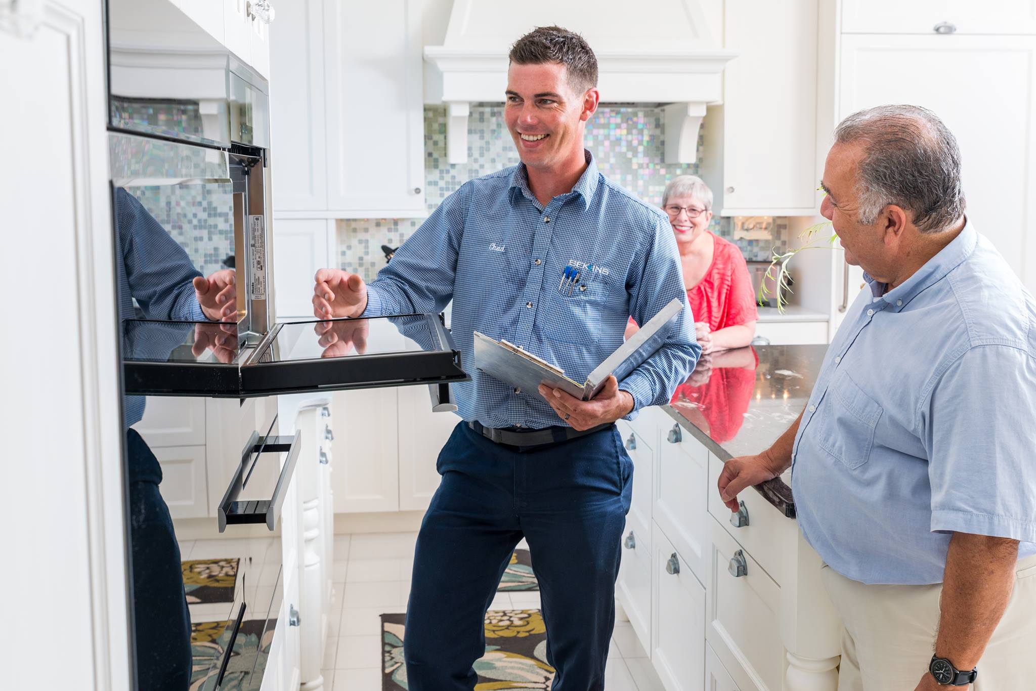 A Bekins appliance expert demonstrating how an oven works to a user 