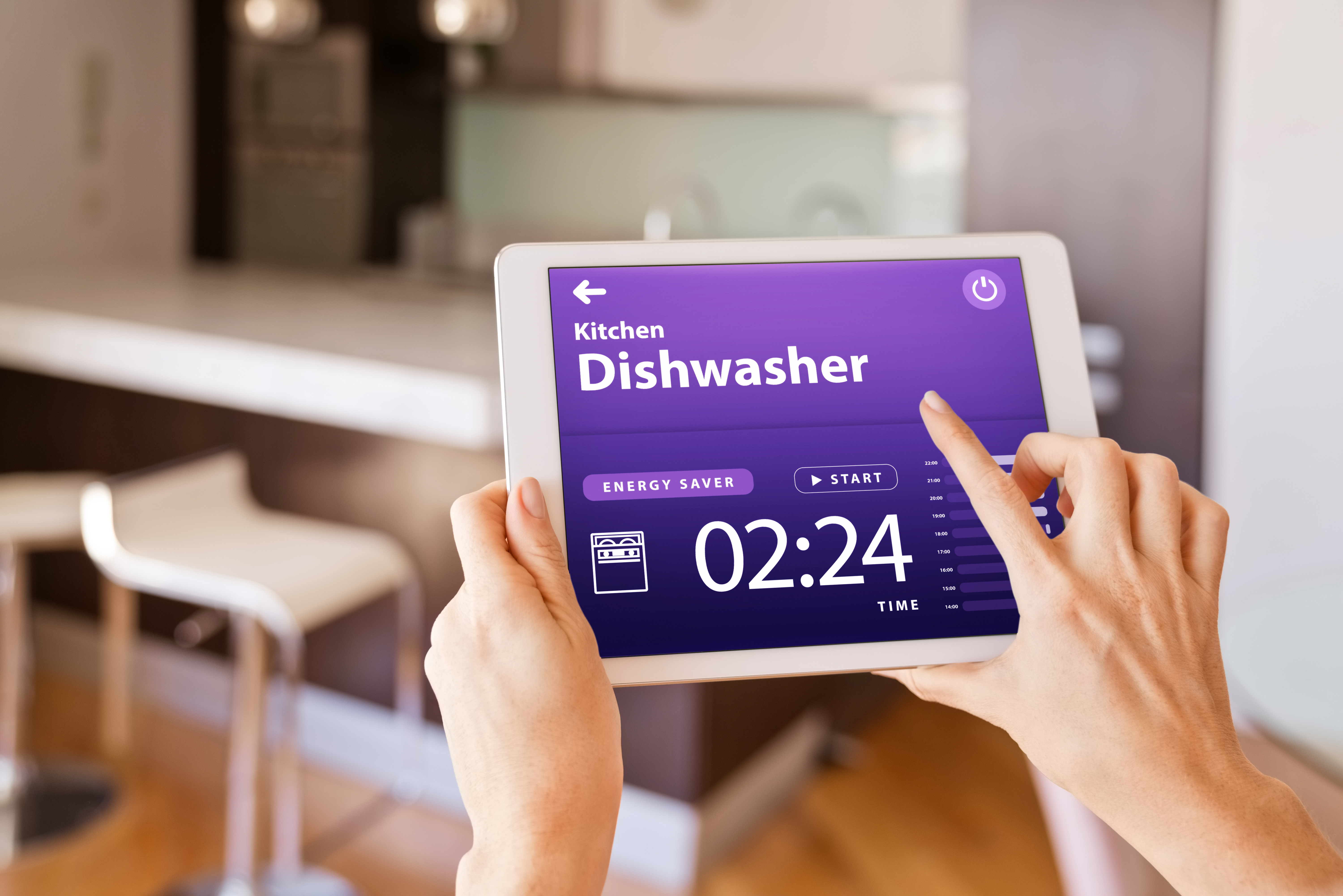 A person programming a dishwasher from a smart device 