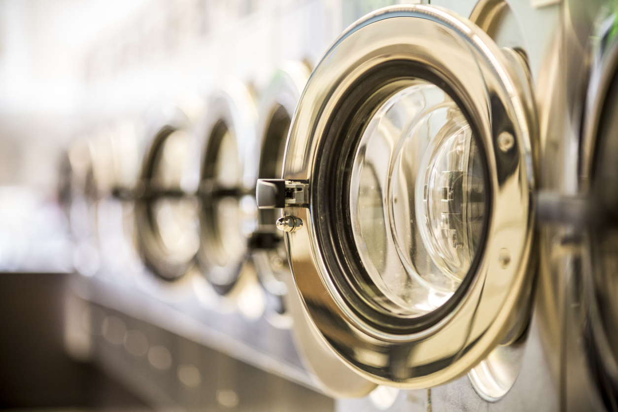 closeup of lined-up commercial front load dryers