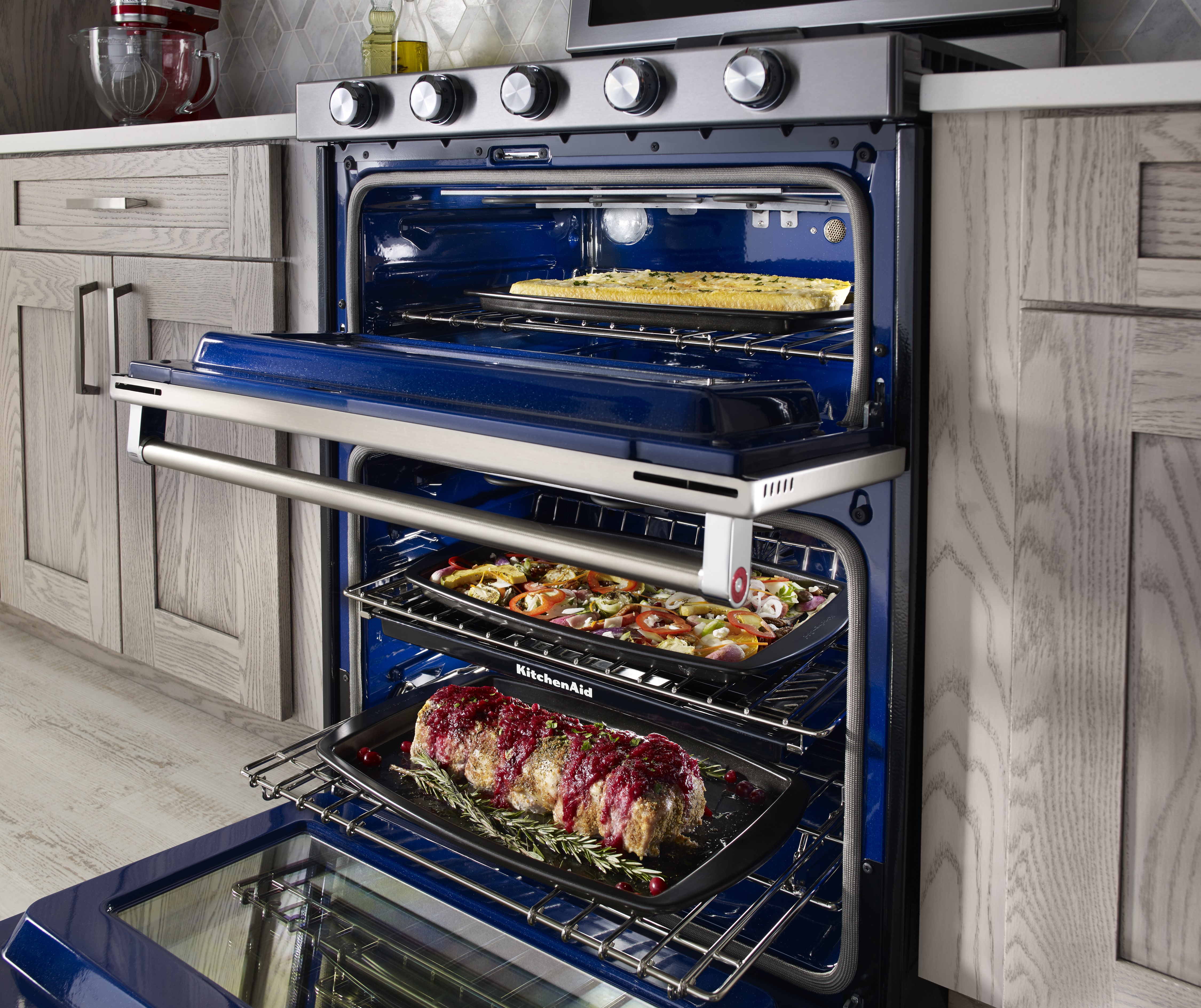 KitchenAid 30” Stainless Steel Freestanding Gas Double Oven Range revealing baked meals