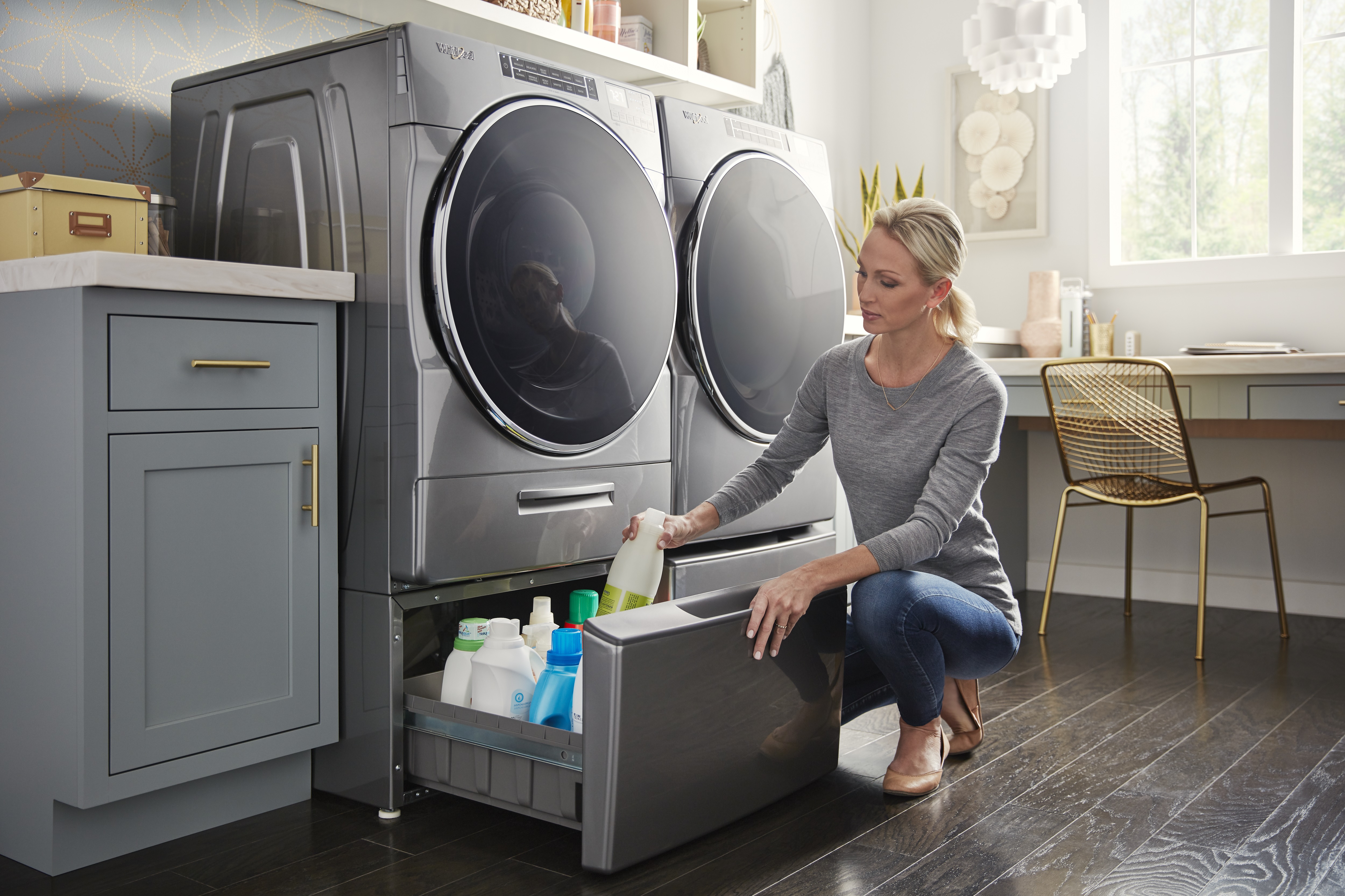 A woman removes detergent from a washing machine