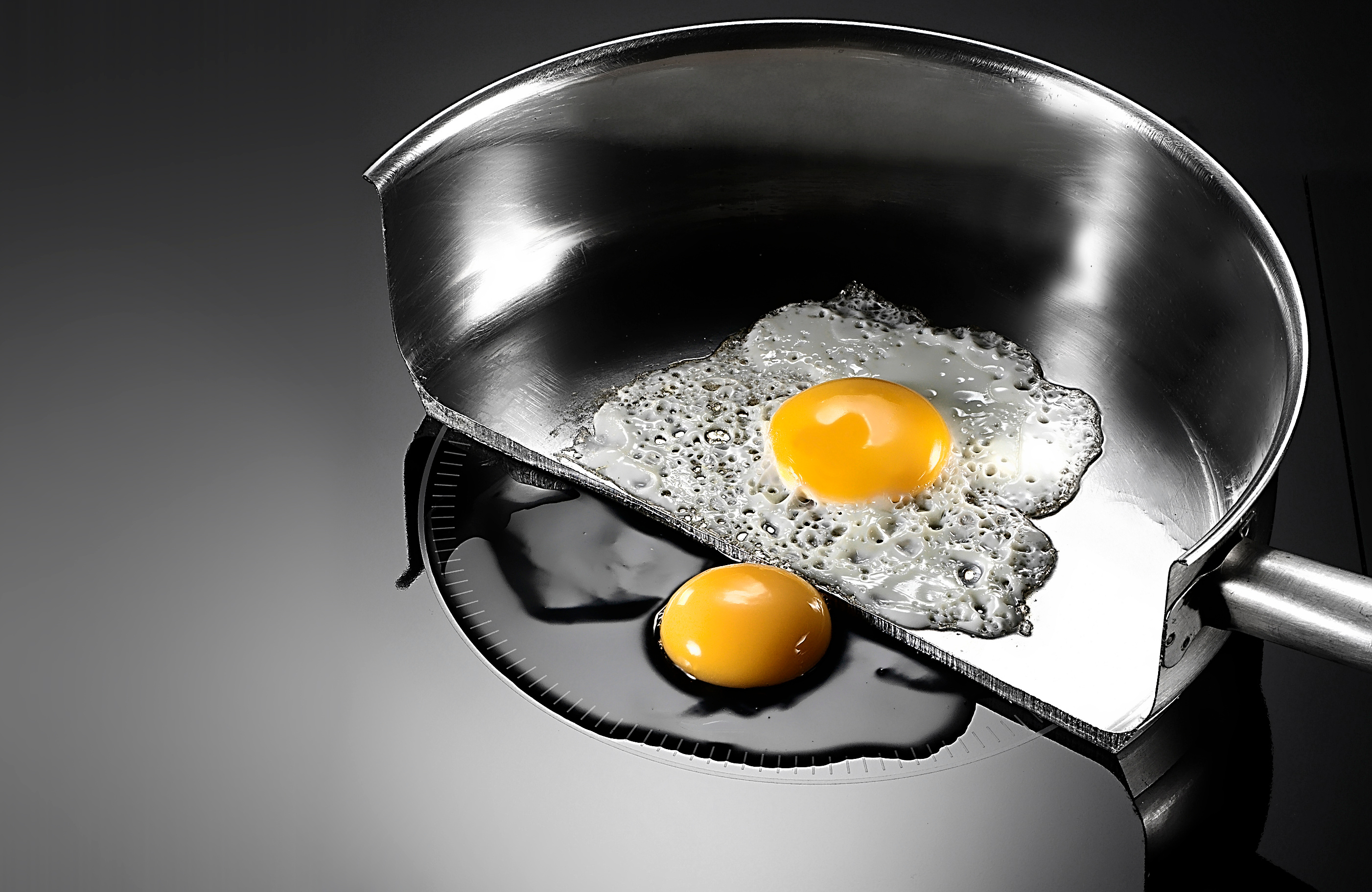 A pan has been cut in two to reveal the effects of induction cooking on cookware vs stovetop
