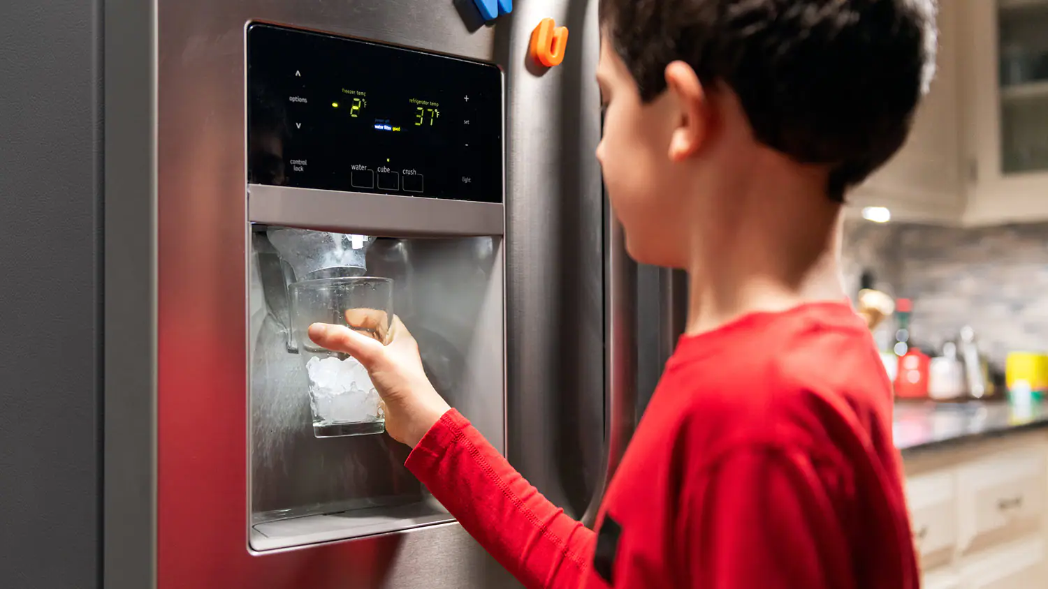 Boy Getting Ice From Refrigerator