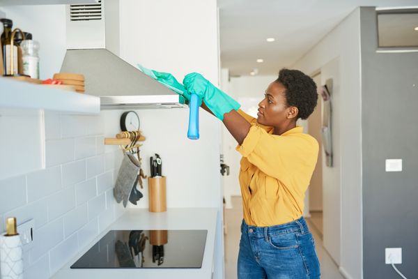 Woman cleaning range hood