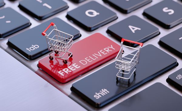 Mini shopping carts on keyboard keys saying free delivery 