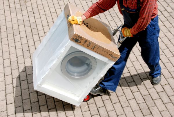 A man hauling a washing machine 