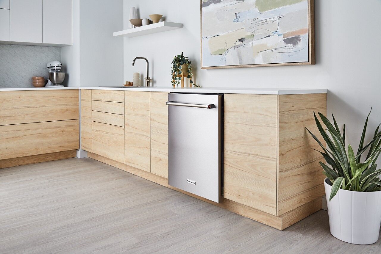 Wide view of a kitchen with a KitchenAid dishwasher  