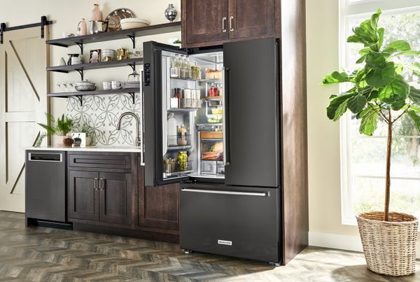 The KitchenAid KRFC704FBS black counter depth refrigerator in a kitchen