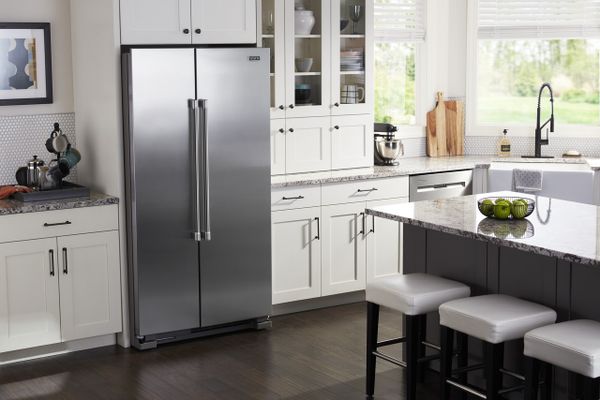 A Maytag side by side refrigerator in a kitchen 