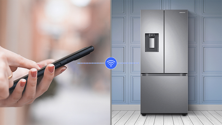 A person using the Wi-Fi feature on a Samsung French door refrigerator 