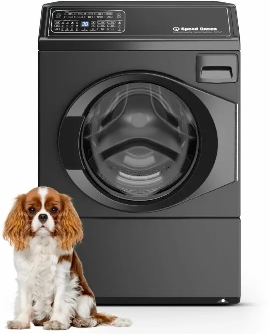 A cocker spaniel in front of a black Speed Queen FF7 washer 