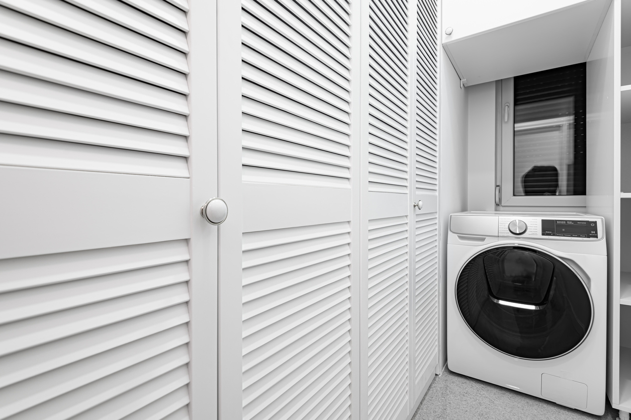A washer dryer combo in a closet  