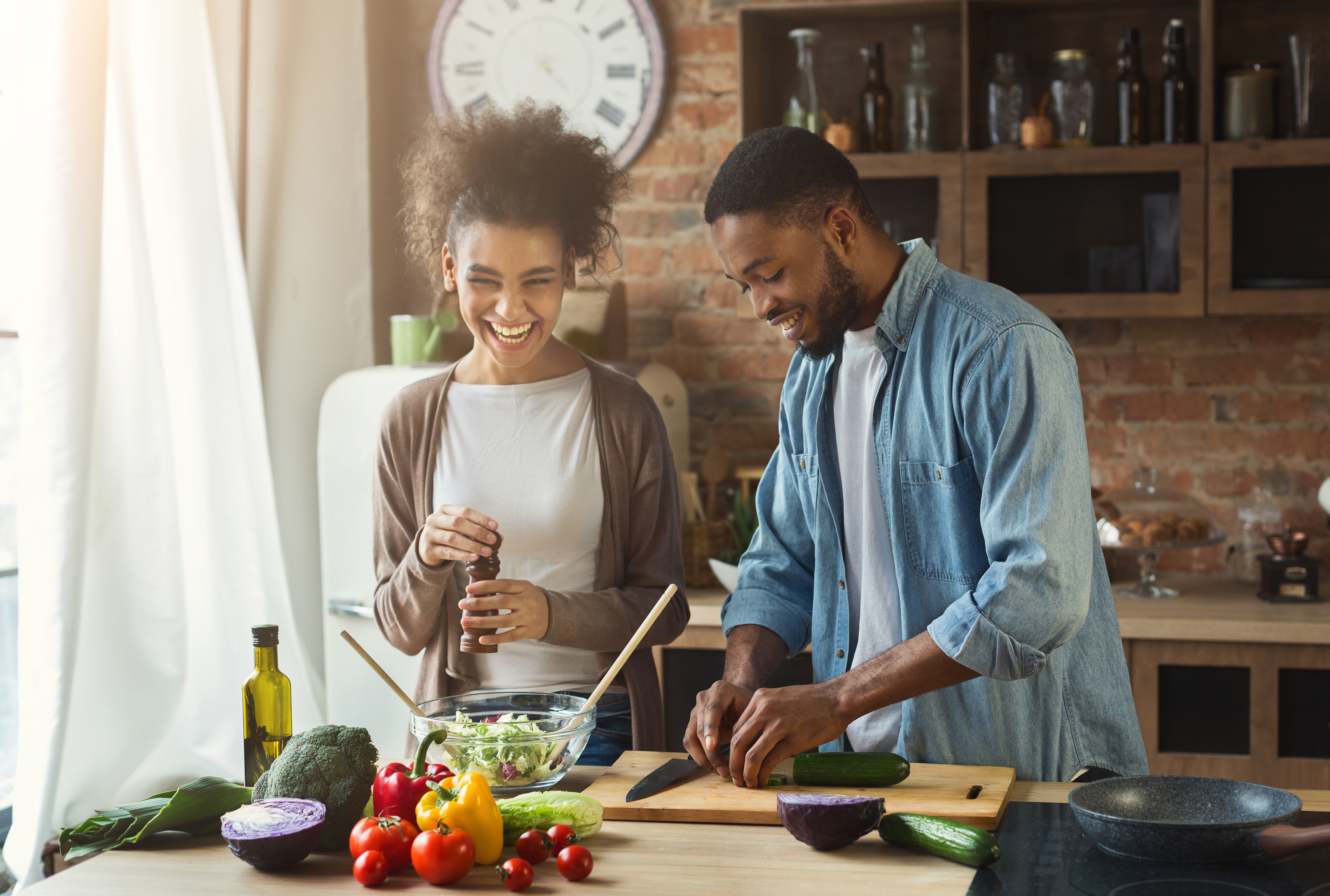 iStock Credit: Prostock-Studio A young couple smiling while they cook